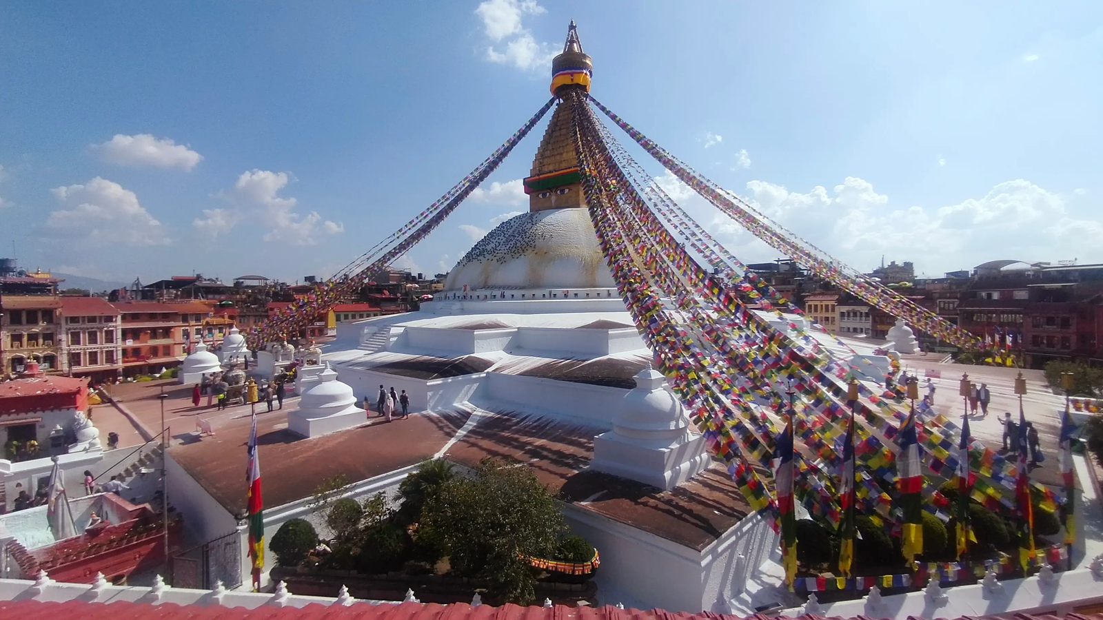 Boudhanath Stupa monks walking — traditional robes and prayer beads