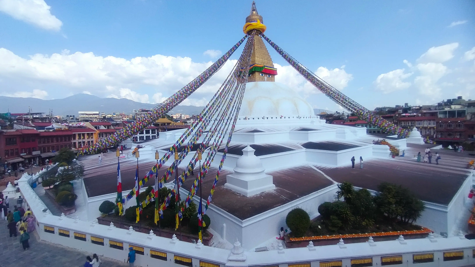 Boudhanath Stupa pilgrims circumambulating with prayer wheels