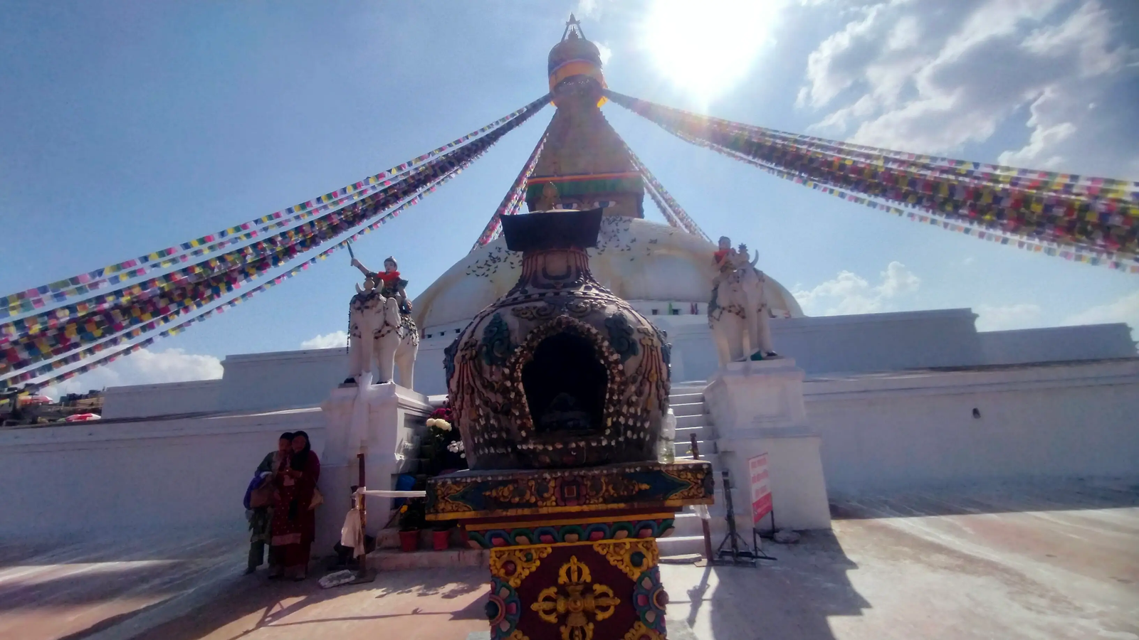 Boudhanath Stupa visitors offering butter lamps and incense