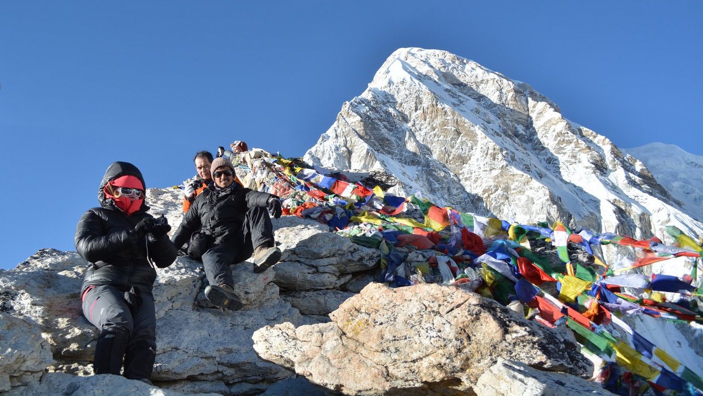 Trekkers hiking toward Everest Base Camp with snow-capped peaks in the background