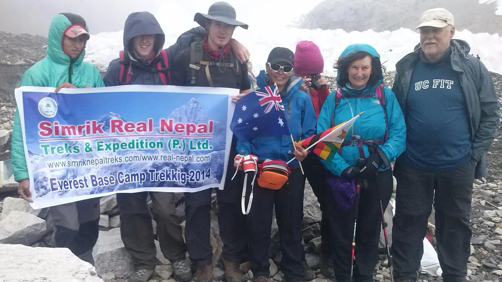 Trekking team with Simrik Real Nepal banner at Everest Base Camp in the Khumbu region of Nepal