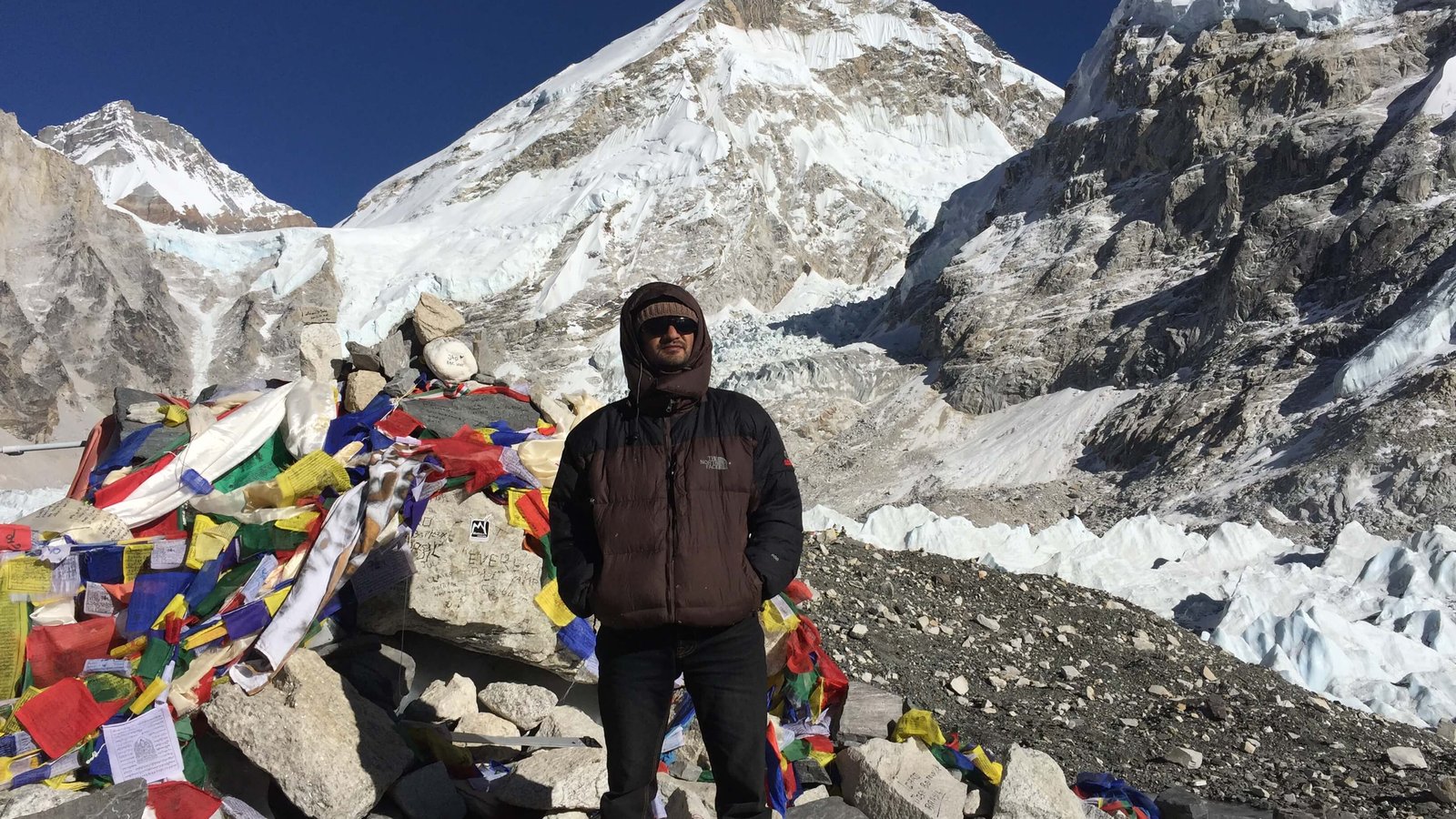 Everest Base Camp with colorful prayer flags and Khumbu Glacier