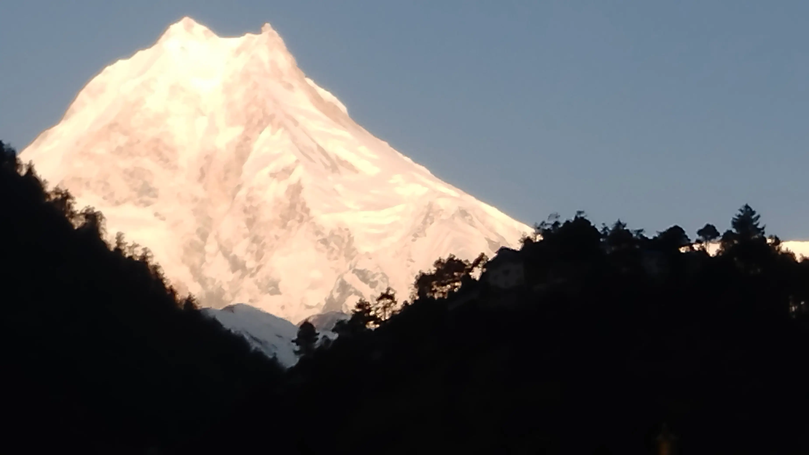 Golden sunrise on Mount Manaslu seen from the Lho village viewpoint on the Manaslu Circuit Trek.