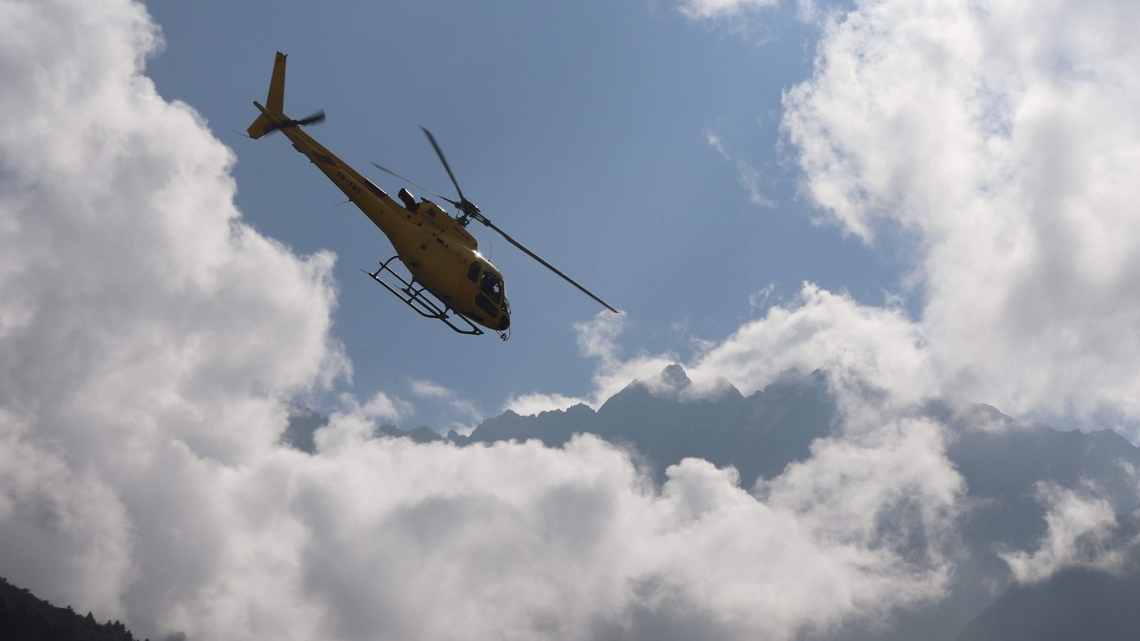 Luxury helicopter flying over the Himalayas offering panoramic views of Mount Everest and surrounding peaks in Nepal