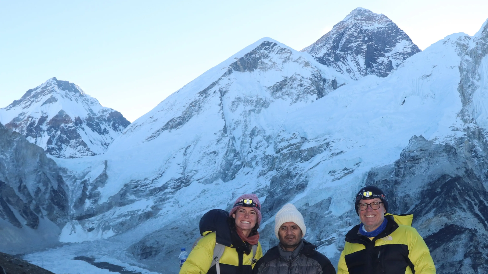 Hikers trekking toward Everest Base Camp with stunning views of Mount Everest and nearby Himalayan peaks