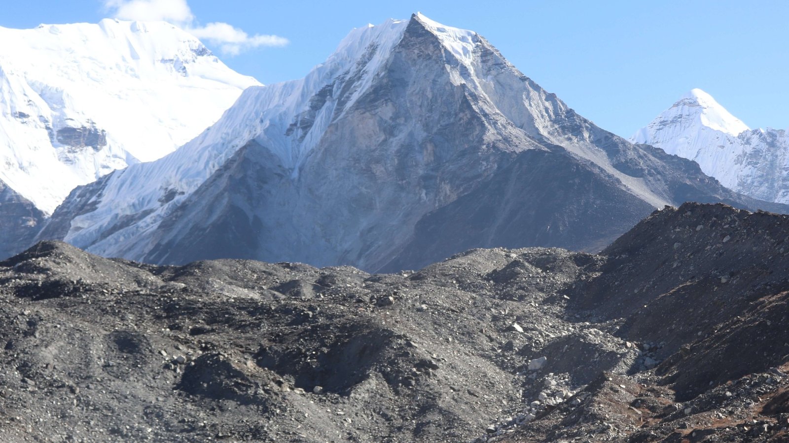 Climbers ascending snowy slopes of Island Peak with stunning Himalayan backdrop under clear blue sky