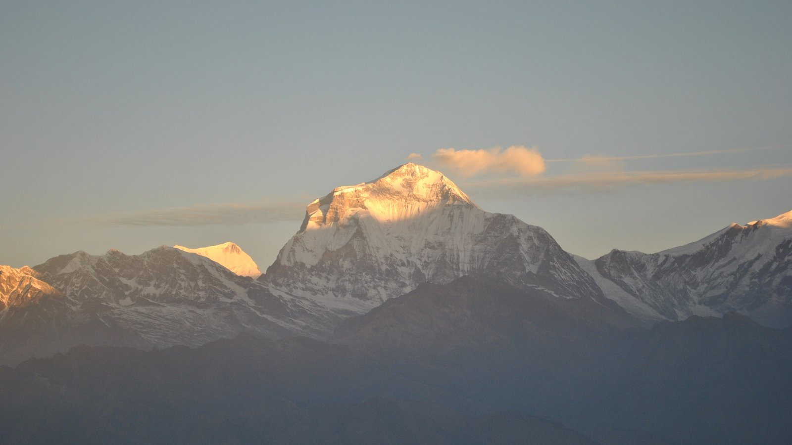 Towering Dhaulagiri Himal, Nepal’s seventh highest peak, blanketed in snow and rising sharply above the Kali Gandaki Valley under a cloudless Himalayan sky.