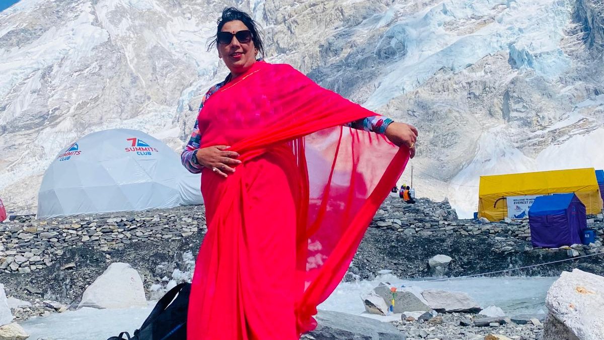 A Nepalese woman wearing traditional Nepali dress, standing proudly at Mount Everest Base Camp