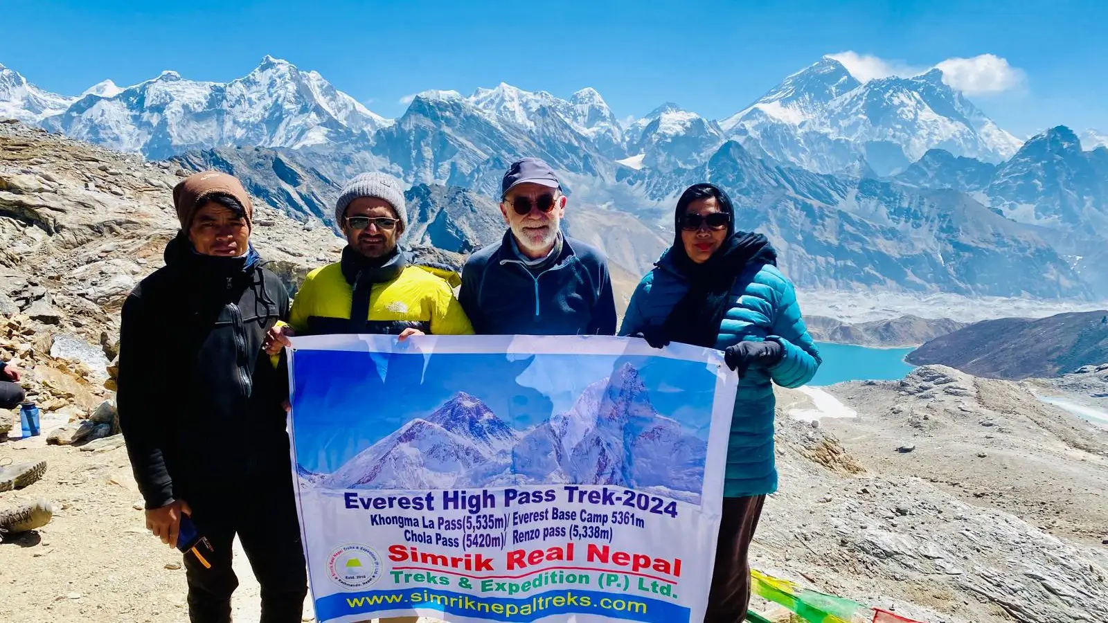 Trekkers crossing Renjo La Pass (5,360 m) on the Everest Three Passes Trek, enjoying panoramic views of Mount Everest, Cho Oyu, and turquoise Gokyo Lakes.