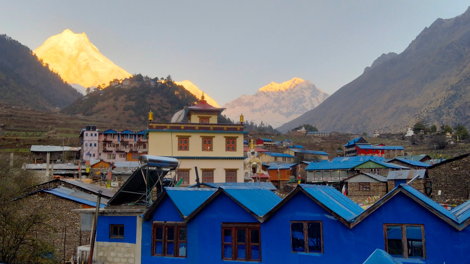 Sunrise view from a rooftop hotel in Lho Village on the way to the Manaslu Circuit Trek, with Mount Manaslu glowing in the morning light in the Nepal Himalayas.