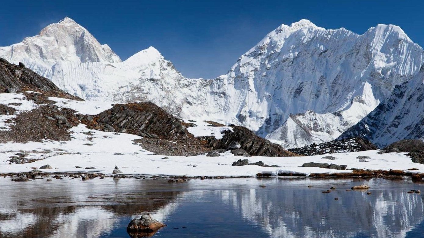 Trekker approaching Mount Makalu Base Camp with towering Himalayan peaks in view