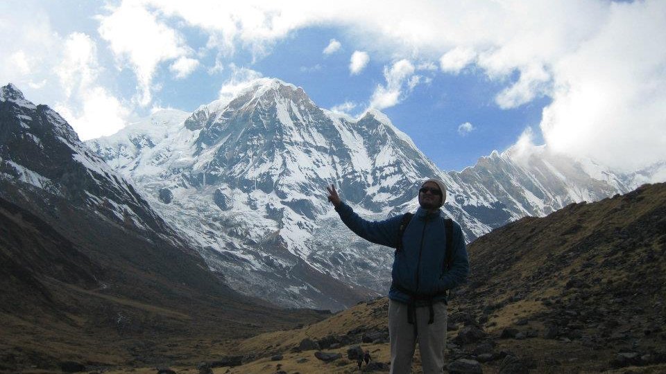 Trekkers approaching Annapurna Base Camp with panoramic views of the Annapurna massif in Nepal