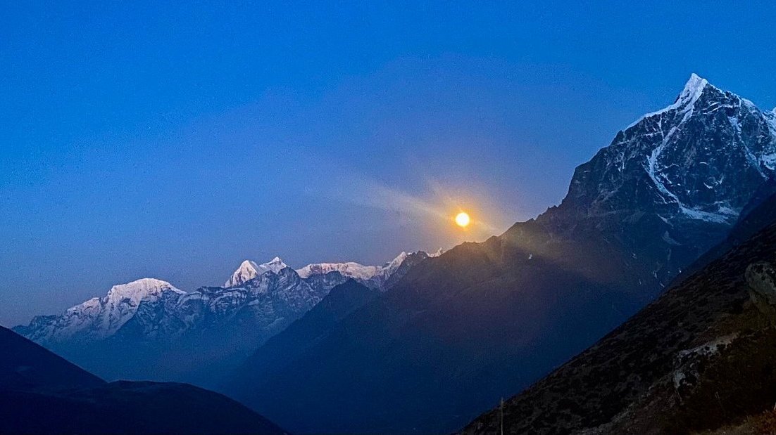 Sunrise over the Himalayas on the trail to Kongma La Pass (5,535m) with golden peaks illuminating the rugged mountain landscape