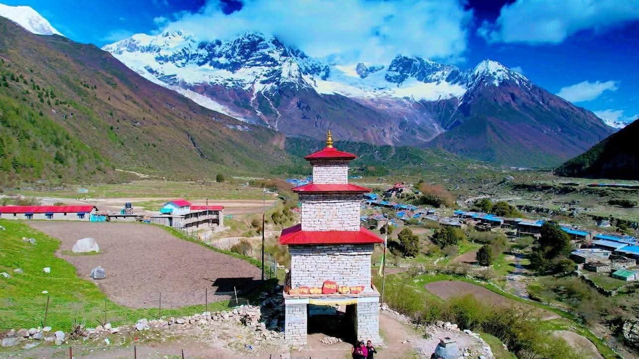 Chorten in Samagaon with Mount Manaslu towering in the background under clear Himalayan skies