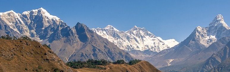 Trekker hiking towards Everest Base Camp with snow-capped mountains in background